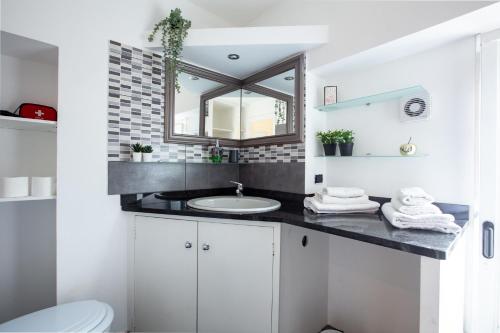 a bathroom with a sink and a mirror at Monza-Center, Modern Apartment in Monza