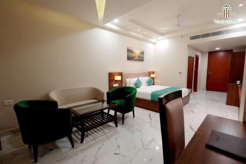 a hotel room with a bed and a table and chairs at The Forest Hill Hotel in Haridwār