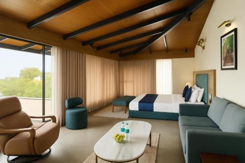 a hotel room with a bed and a couch at Sahyadri Farms agro tourism-Villa and cottages 