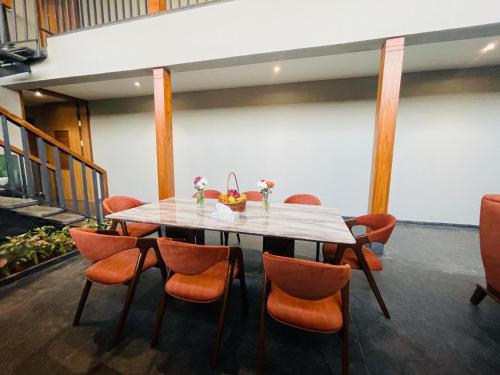 a dining room with a table and chairs at Sahyadri Farms agro tourism-Villa and cottages 
