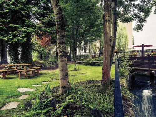 a park with a picnic table and trees at Mercure Perth Hotel in Perth