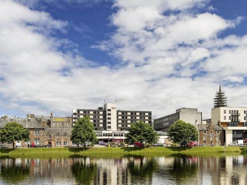 a city with buildings and a body of water at Mercure Inverness Hotel in Inverness