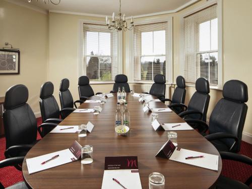 a large conference room with a long table and chairs at Mercure Maidstone Great Danes Hotel in Maidstone