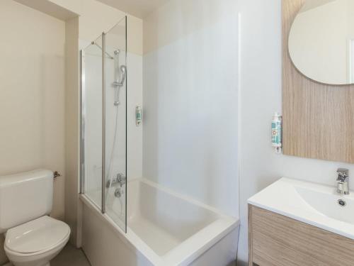 a bathroom with a shower and a toilet and a sink at Aparthotel Adagio Access Paris La Villette in Paris