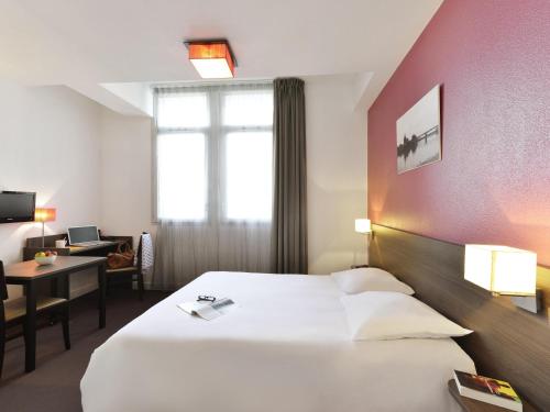 Postel nebo postele na pokoji v ubytování Aparthotel Adagio Access Toulouse St Cyprien