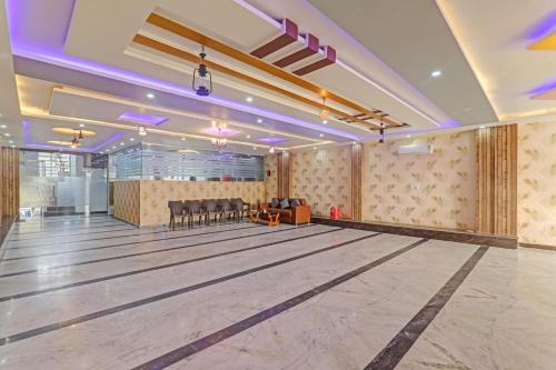 a bowling alley in a hall with tables and chairs at Collection O Shivashakti Grand Near Chaudhary Charan Singh International Airport in Banthra Sikandarpur
