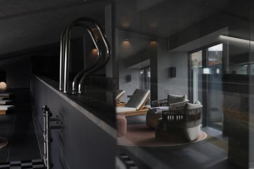 a kitchen with a sink and a living room at Pullman Riga Old Town in Rīga