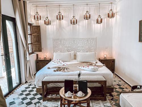 a bedroom with a large bed with two tables at Riad NL&S Collection in Marrakech
