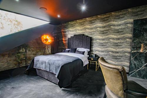 a bedroom with a bed and a stone wall at Brierley Club Hideaway Chic 7 Star Retreat in Rishton