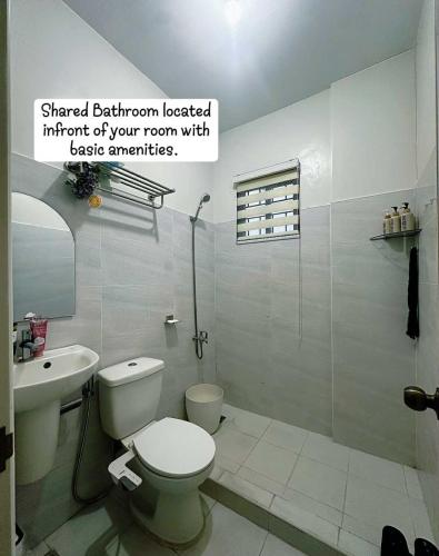 a bathroom with a toilet and a sink at Casa Ariana in Pulilan