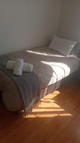 a bed in a bedroom with the sun shining on it at Thee House - Mkamba Gardens in Pietermaritzburg