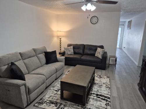 a living room with a couch and a table at Emmanuel Fulton Park Condominium in Tulsa