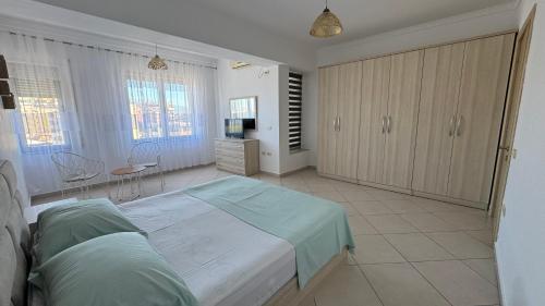 une chambre avec un lit et une télévision dans l'établissement Labeat Apartment, à Shkodër
