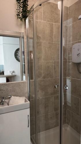 a bathroom with a shower and a sink at SOBO Studio in Bournemouth