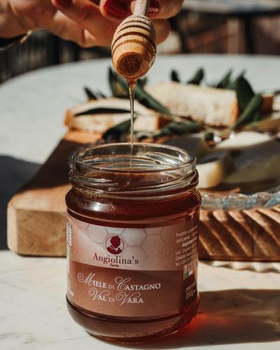 a honey being poured into a jar of food at Angiolina's Farm in Levanto