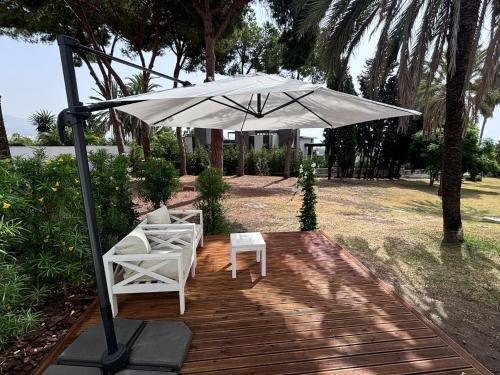 a patio with two chairs and an umbrella at Palacio Suites Marbella in Marbella