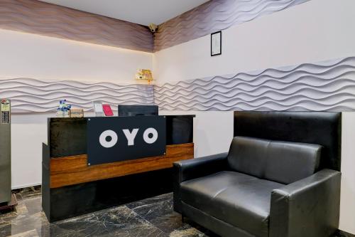 a black leather chair in a room with a tv at Hotel O The Superior in Bhatha