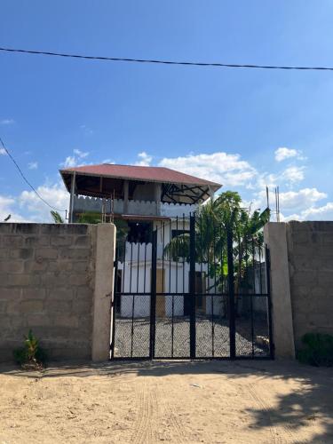 a gate in front of a building at Dhow House in Bagamoyo