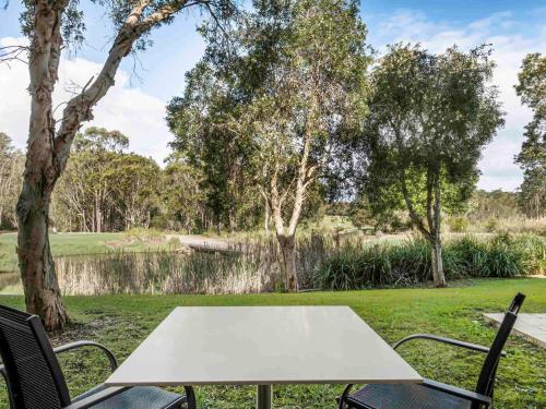 a white table and chairs in a yard at Mercure Kooindah Waters Central Coast in Wyong