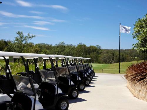 a line of golf carts parked at a golf course at Mercure Kooindah Waters Central Coast in Wyong