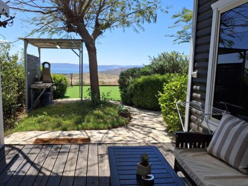 a patio with a couch and a table on a house at דובדבן בגולן in Had Nes