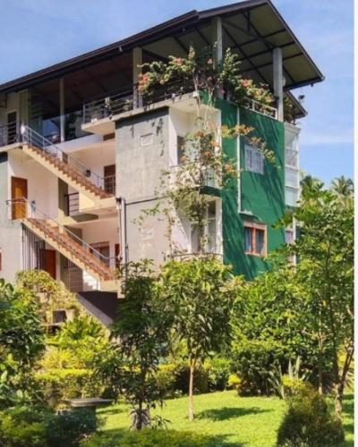 a building with plants on the side of it at River way in Ratnapura
