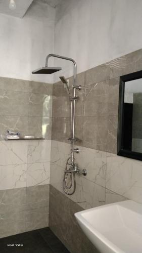 a shower in a bathroom with a tub and a sink at River way in Ratnapura