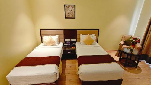 Cama o camas de una habitación en ASR Parklane, A Bergamont Hotel - Hosur