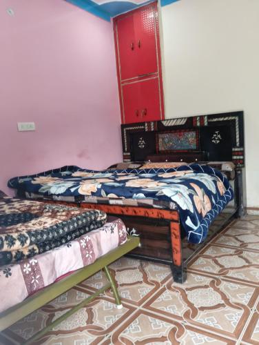 a room with two beds and a red cabinet at Global home stay in Sari