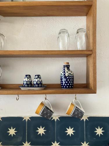 a shelf with blue and white vases on it at Dhow House in Bagamoyo