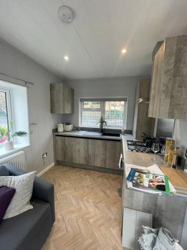 a kitchen with a couch and a counter top at Sutton Fields Chalet in Preston on the Hill