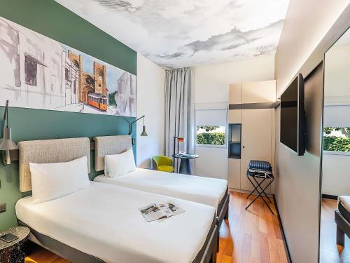 a hotel room with a large bed in a room at Hotel Ibis Lisboa Parque das Nações in Lisbon