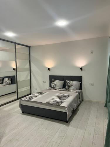a bedroom with a large bed and a large mirror at Гагарина 119 in Dnipro
