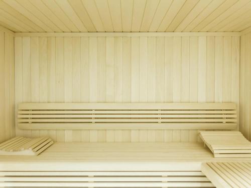a room with two benches in a room with white walls at Hotel Ibis Lisboa Parque das Nações in Lisbon