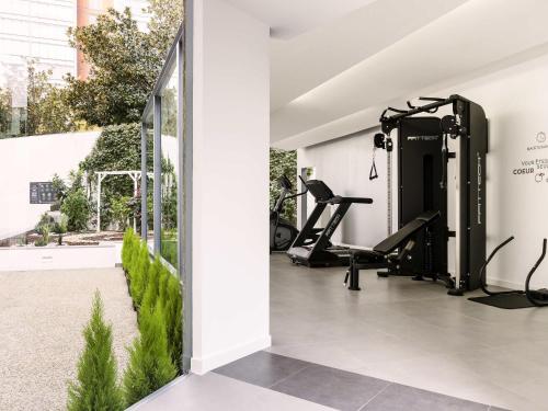 a gym with treadmills and ellipticals in a building at Hotel Ibis Lisboa Parque das Nações in Lisbon
