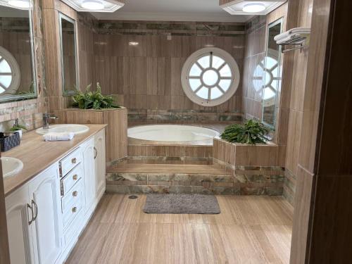 a large bathroom with two sinks and a tub at Palacio Suites Marbella in Marbella