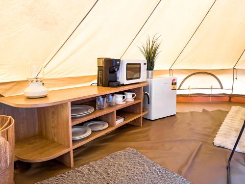 a microwave and a refrigerator in a tent at Stanthorpe Holiday Park in Severnlea
