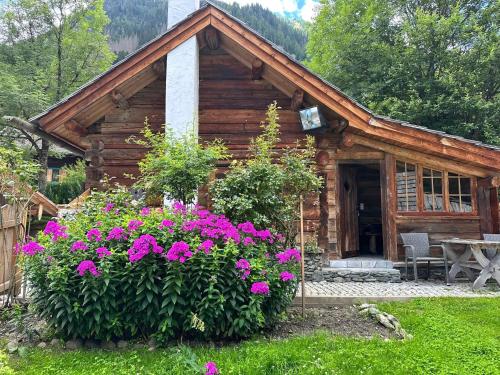 a log cabin with flowers in front of it at Romantikhütte in Flattach