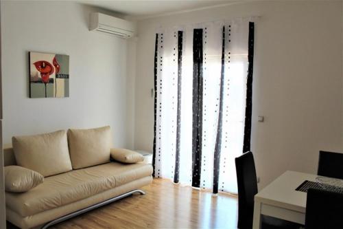a living room with a couch and a table at Apartment Jure in Primošten