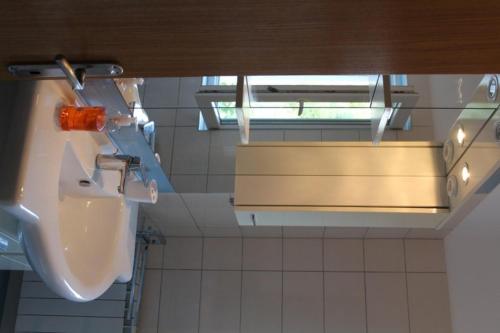 a bathroom with a urinal and a sink at Apartment Jure in Primošten