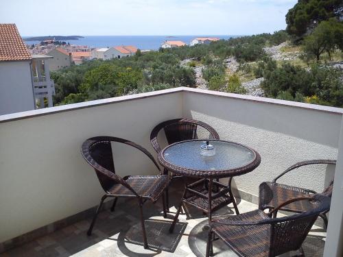 a table and four chairs on a balcony at Apartment Jure in Primošten