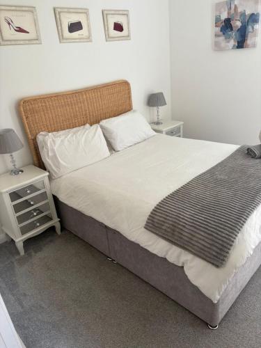 a bedroom with a large bed with two night stands at City Stay Haven - Coop Live - Etihad - Sleeps 9 - Free Parking in Manchester