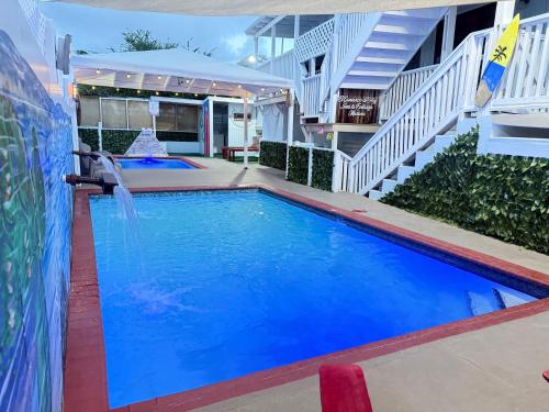 a swimming pool with a waterfall in a building at Cabana Playa Santa Apto C Piscinas Solar Energy in Guanica