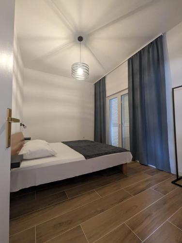 a bedroom with a large bed and a light at Apartment Joso in Primošten