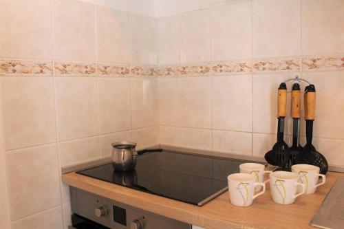 a kitchen with a counter with cups and knives at Apartment Nana in Primošten