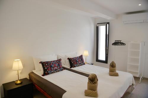a bedroom with a bed with two shoes on it at Finca Sol y Mar Es Trenc in Campos