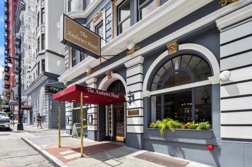 a building with a red awning on a city street at The Andrews Hotel in San Francisco