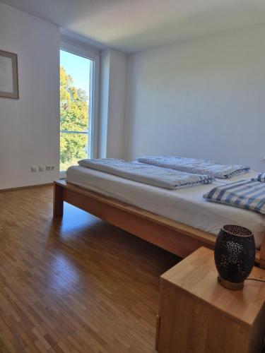 a large bed in a room with a window at Luxury Penthouse 15 Min to Wiesn with Parking, Balcony in Munich