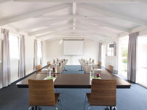 a large conference room with a long table and chairs at ibis Styles Canberra in Canberra