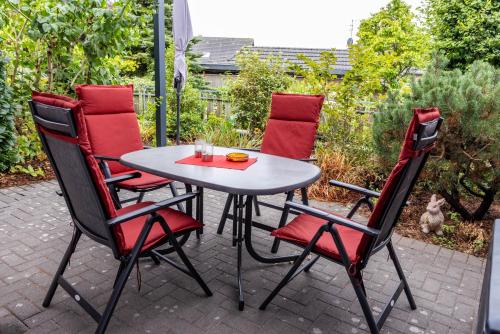 a table and four chairs on a patio at Ferienwohnungen Schoofs in Kalkar